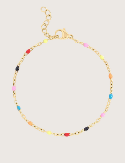 Gold chain bracelet with colorful beads on an ivory background