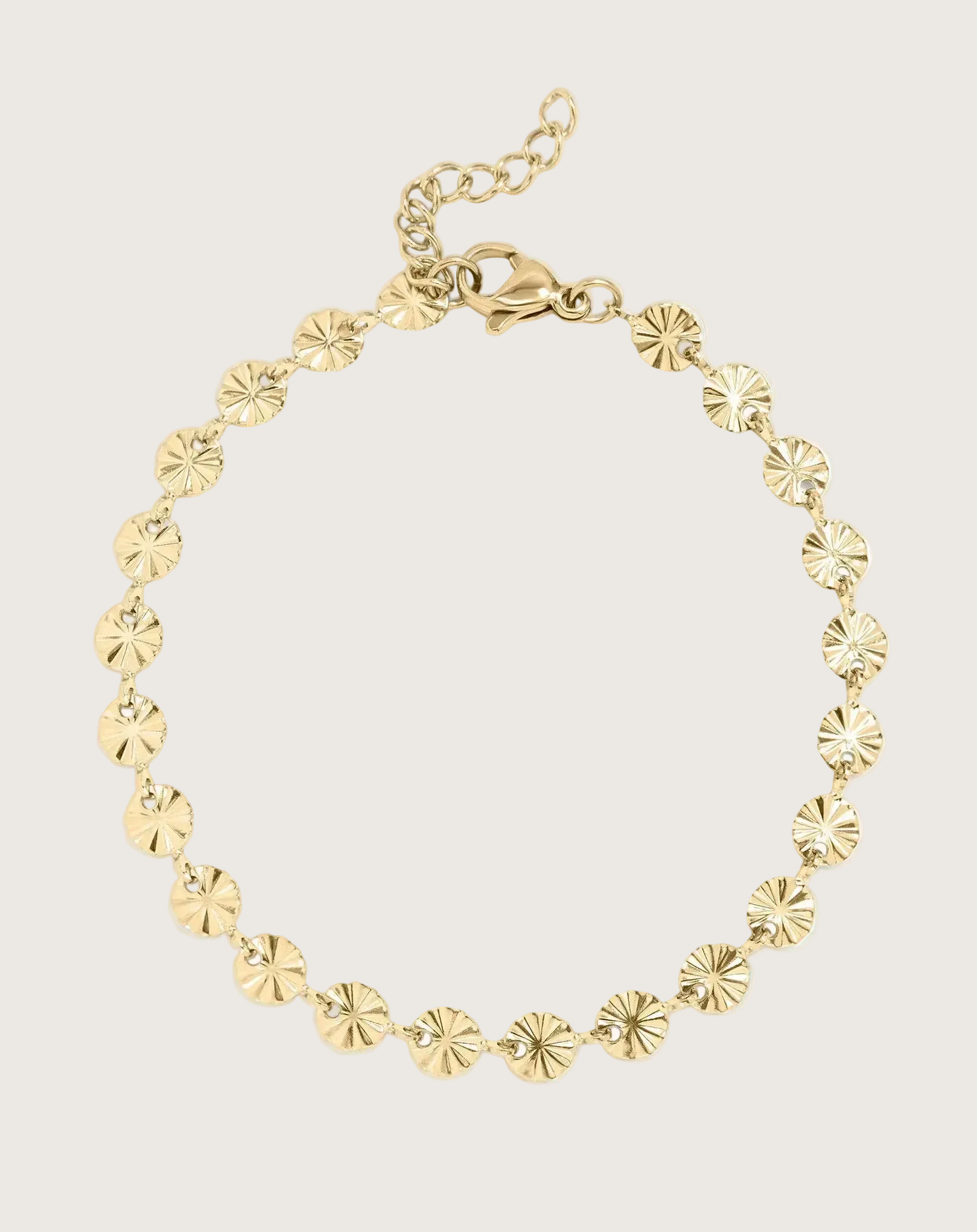 Gold Sunburst Chain Bracelet on an Ivory Background