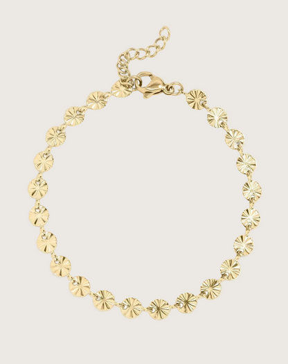 Gold Sunburst Chain Bracelet on an Ivory Background